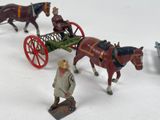 a lot of toy figurines of horses and carriages