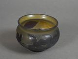a small glass vase that has a flower design on it