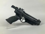 the gun is sitting on a clear stand on a white surface