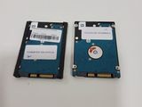 two hard drives sitting side by side on a table