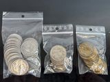 three bags of coins sitting on top of a table next to each other