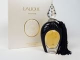 a close up of a bottle of perfume next to a box