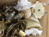 a cardboard box filled with assorted items like lamps and lamps