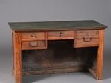 an old wooden desk with two drawers and a leather top