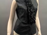 a mannequin wearing a black shirt and tan pants