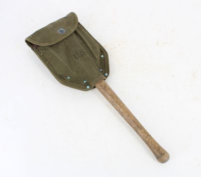 a small shovel with a wooden handle on a white surface