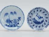 two blue and white plates with designs on them