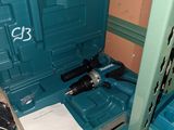 a blue tool box sitting on top of a shelf in a room