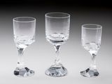 three empty wine glasses sitting next to each other on a table