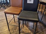 three leather bar stools with a price tag on them in a store