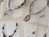 several pieces of jewelry are displayed on a table in a display case