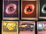 a lot of pokemon cards that are on the table