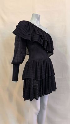 black dress with ruffles on mannequin neckline and long sleeves