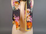 an image of a black and yellow floral scarf on a mannequin