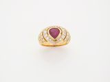 an 18k yellow gold ring set with a pear shaped ruby and diamonds