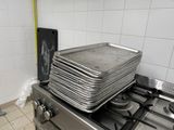 a stack of pans sitting on top of a stove in a kitchen