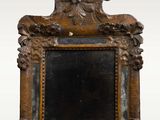 an antique mirror with a wooden frame and a decorative design