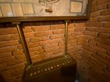 a brick wall with a clock on it in a room