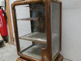 a glass display case with a clock on top of it