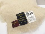 a white pillow with a label on it and a passport