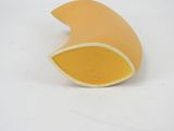 a yellow object that is sitting on a white surface