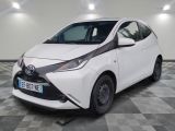 the white toyota ay is parked in a room with a checkered floor