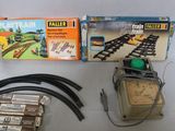 a box of train tracks and a clock on the table