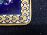 a picture of a blue and yellow tile with a picture of a fish