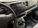 a dashboard of a car with a digital clock on it