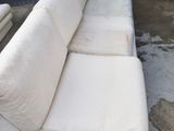 a white couch that is sitting in the middle of a lot