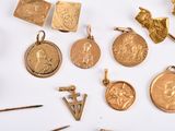 many different types of gold jewelry on a white surface