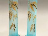 pair of blue glass vases with yellow flowers on them