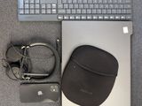 a keyboard, mouse, headphones, and a case on the floor