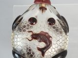 a picture of a glass bottle with a fish on it