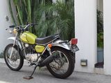 a yellow motorcycle parked on the side of the road