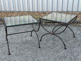 pair of glass and iron side tables on a gravel ground