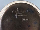a close up of a silver plate with a name on it