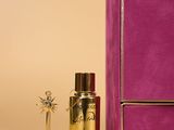 purple box with a bottle of perfume next to it on a table