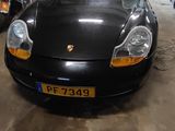 a black sports car parked in a garage next to motorcycles