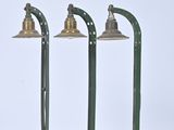 three green street lights sitting next to each other on top of a white surface