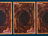 three cards with a picture of a black hole in the middle of them