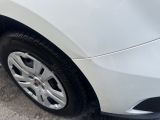 a white car that is parked on the side of the street