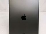 the back of an ipad with a black apple logo on it