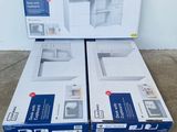 two boxes of microwaves sitting on a pallet in a warehouse