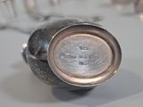 a silver vase sitting on top of a table