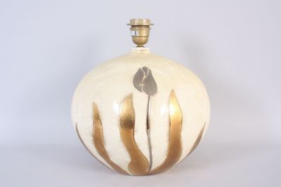 a white and gold vase with a flower on it
