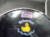 a person holding a plastic bowl with a rubber duck on it