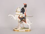 figurine of a man riding on a horse with a sword