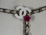 a white belt with a pink bead on it