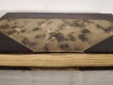 an old book that is sitting on a table